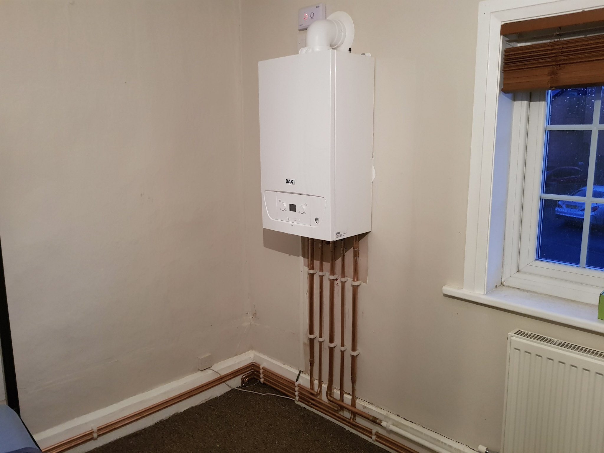 A new Baxi combi boiler and copper pipework finished in a Cheshire home